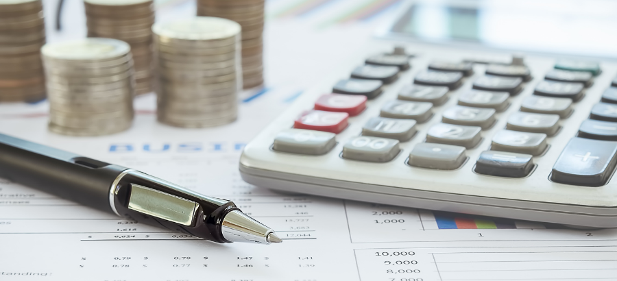 A calculator and coins on a desk
